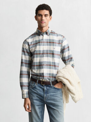 A man looking at the camera wearing a Gant check shirt